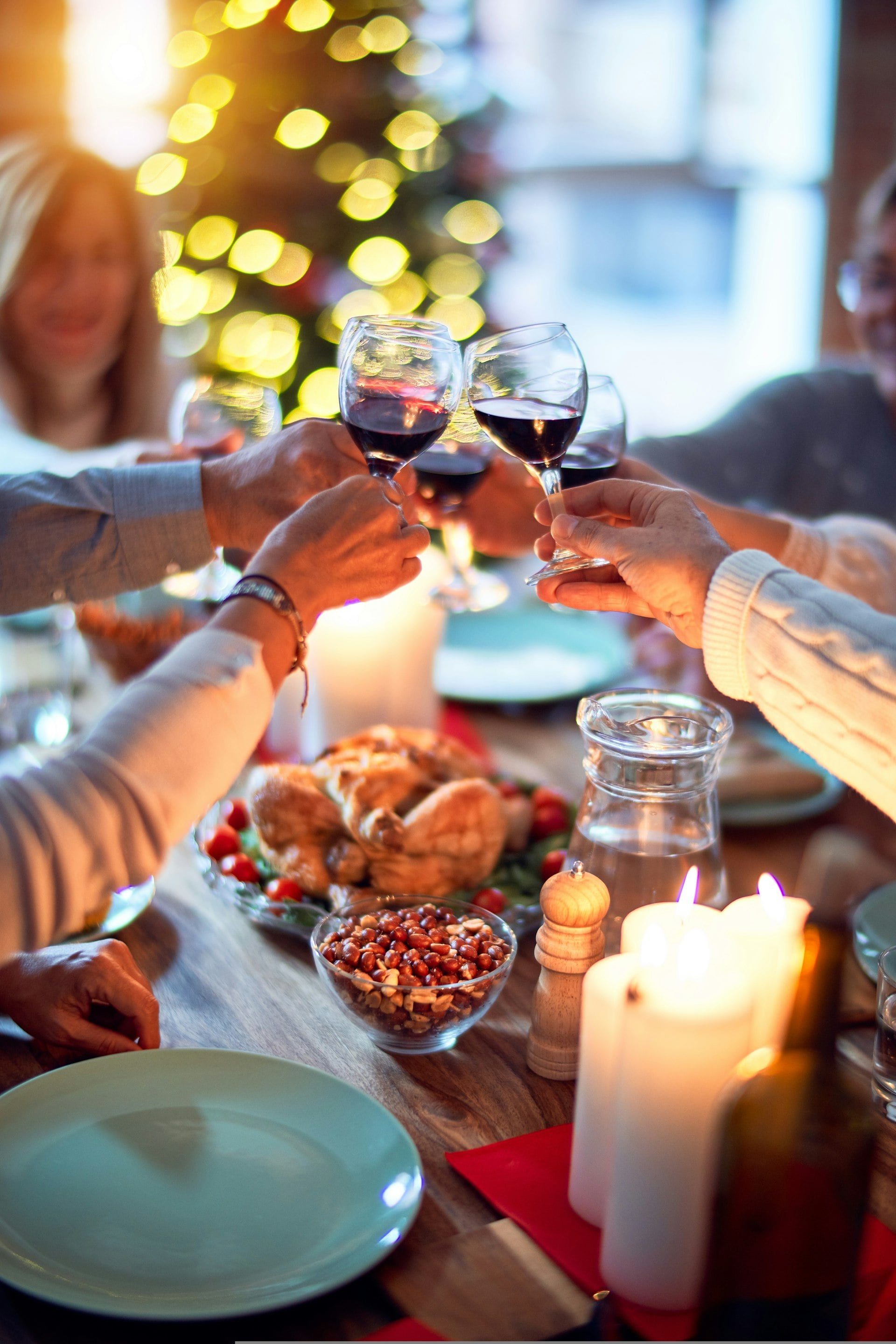 Guests raising glasses over a candlelit dinner table